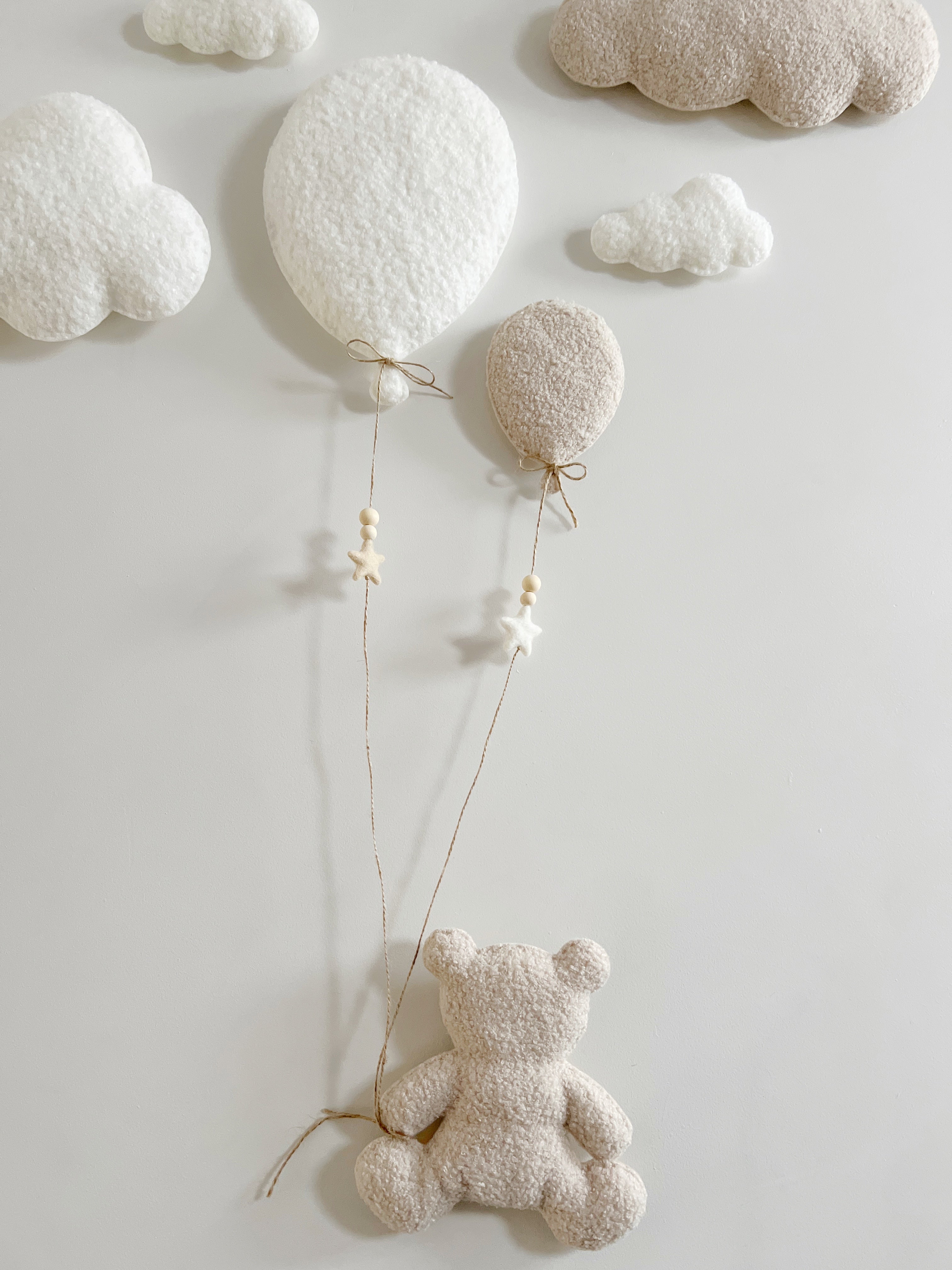 Teddy bear hanging from balloons deals